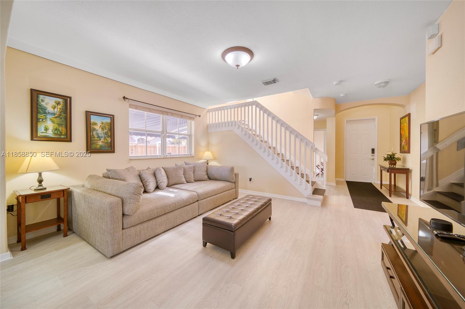 16403 Southwest 79th Lane, Unit 16403 Miami, FL 33193 - Photo 13 of 43 a living room with furniture and a flat screen tv