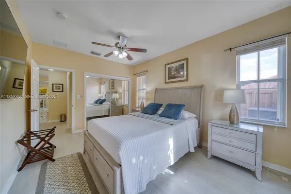 a bed room with a bed and a chandelier