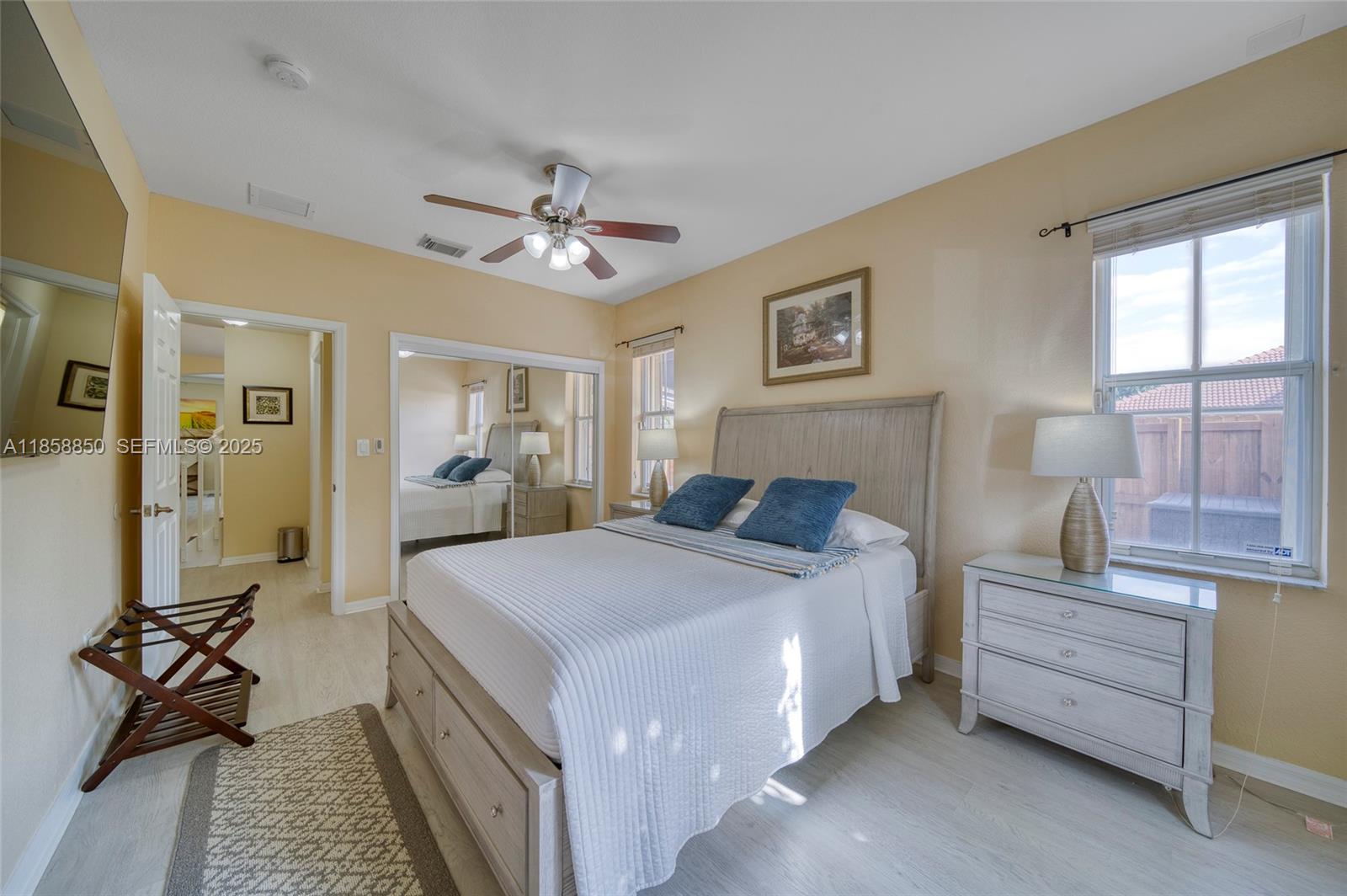 16403 Southwest 79th Lane, Unit 16403 Miami, FL 33193 - Photo 20 of 43 a bed room with a bed and a chandelier