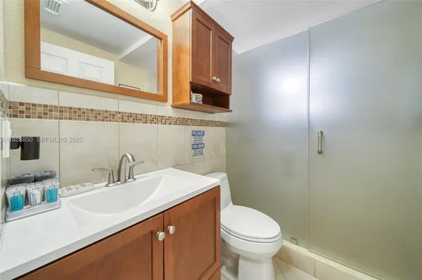 a bathroom with a sink toilet and vanity