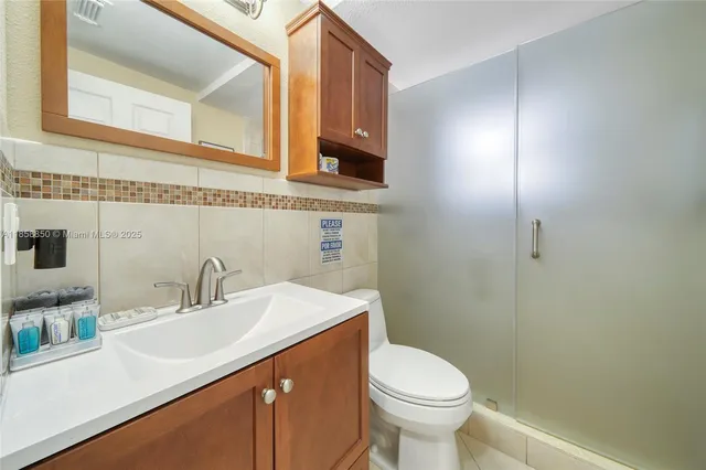 a bathroom with a sink toilet and vanity
