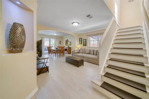 a living room with furniture and a chandelier