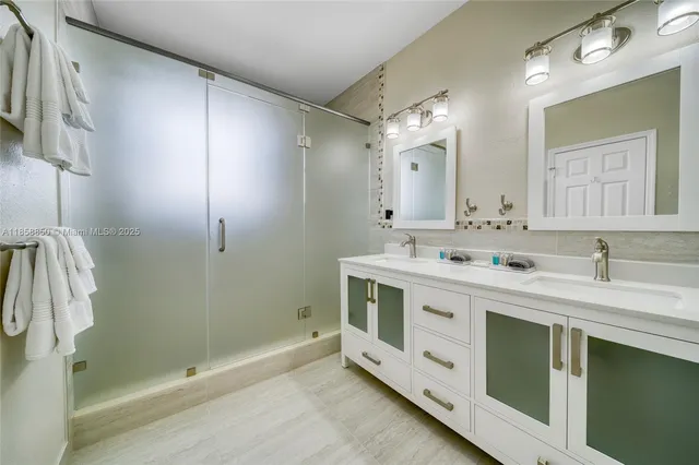 a spacious bathroom with a double vanity sink mirror and