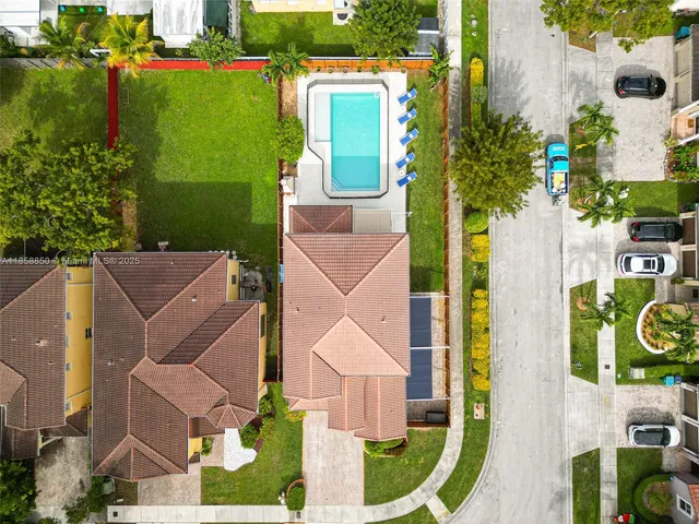 an aerial view of a house with garden space and street view