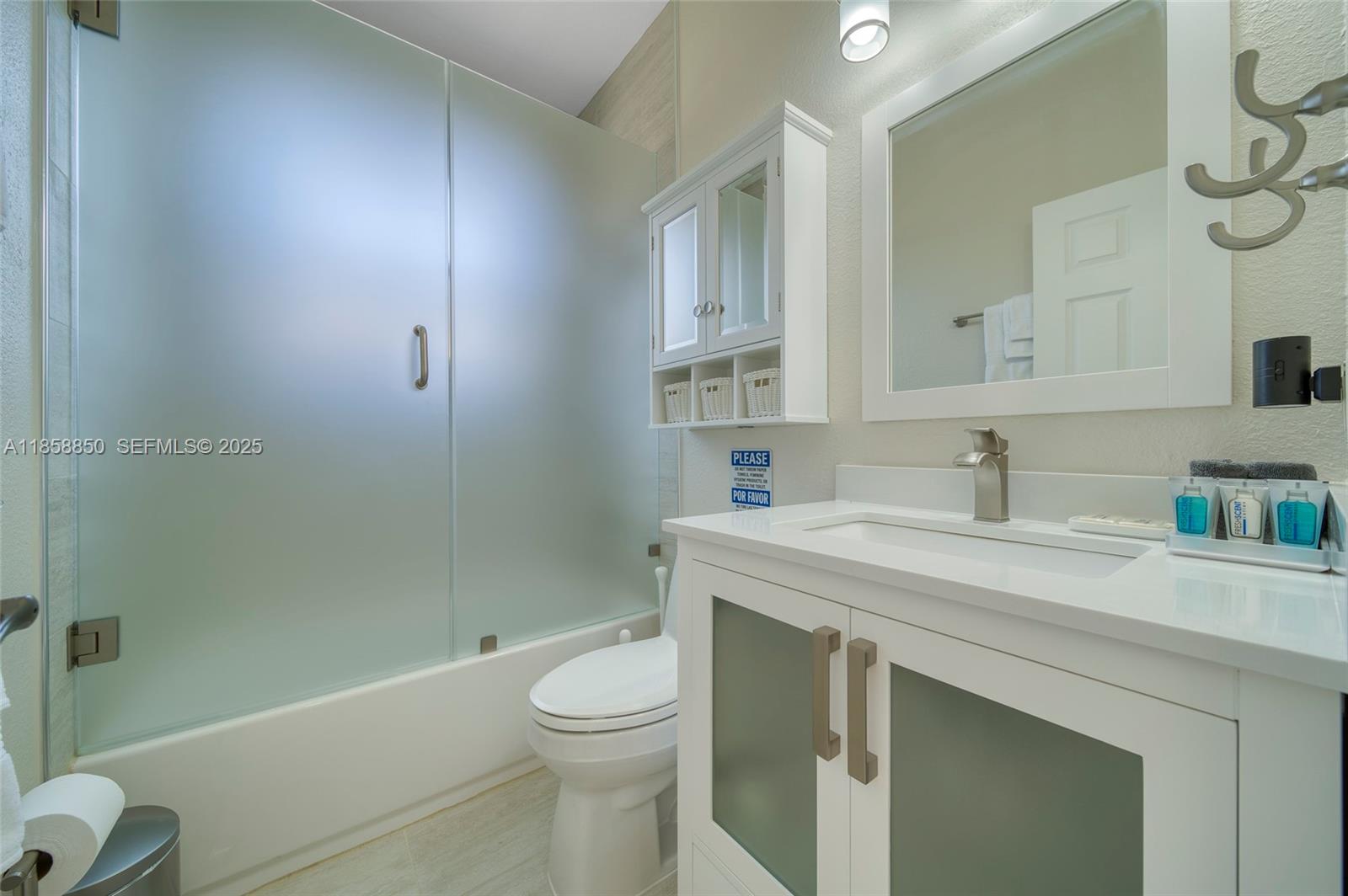 16403 Southwest 79th Lane, Unit 16403 Miami, FL 33193 - Photo 32 of 43 a bathroom with a sink a toilet and shower