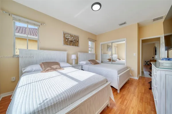 a bedroom with a bed and a lamp