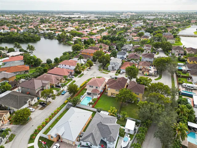 an aerial view of residential houses with outdoor space