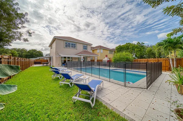 a view of a house with backyard porch and sitting area