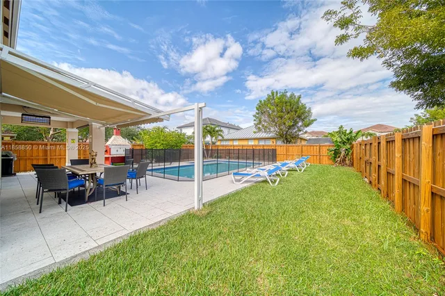 a view of a backyard with sitting area