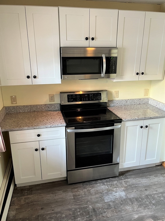 41 Oakhurst Road, Unit 41 Hopkinton, MA 01748 - Photo 4 of 13 a kitchen with granite countertop white cabinets and stainless steel appliances