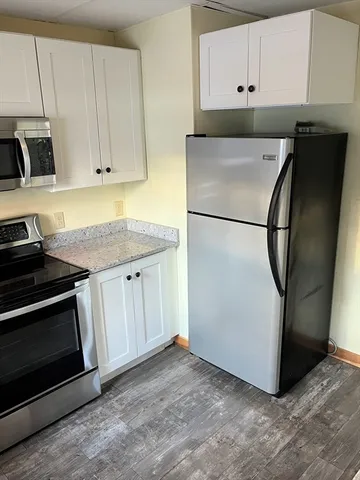 a utility room with cabinets washer and dryer