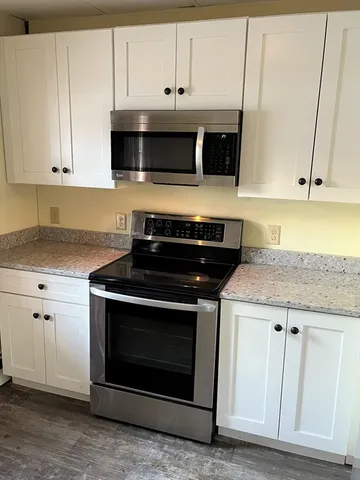 a stove top oven sitting inside of a kitchen