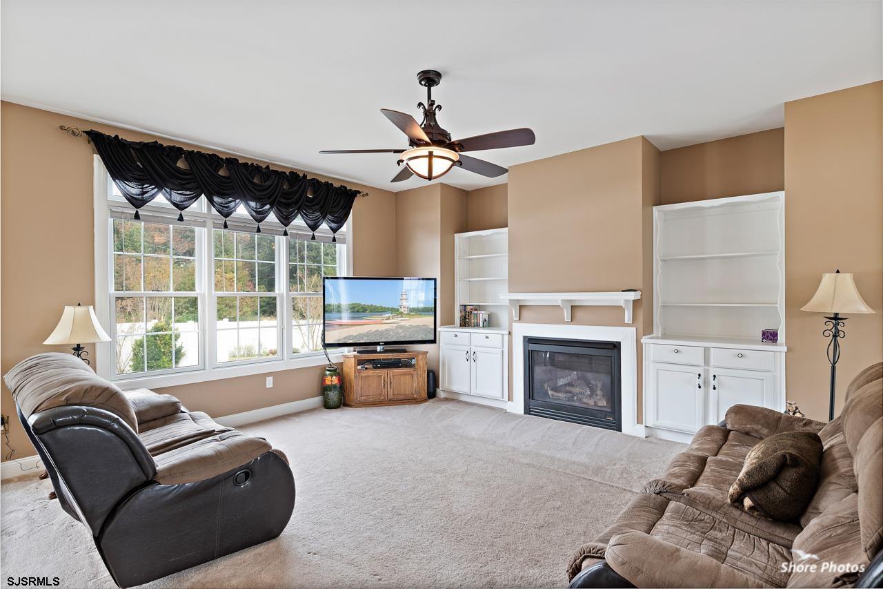 49 Killdeer Hill Road Woodbine, NJ 08270 - Photo 14 of 56 a living room with furniture a fireplace and a flat screen tv