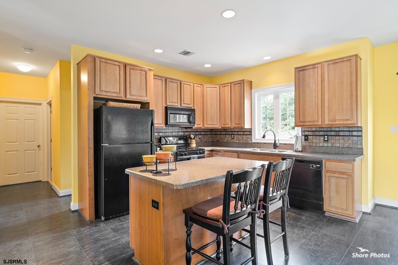 49 Killdeer Hill Road Woodbine, NJ 08270 - Photo 18 of 56 a kitchen with kitchen island granite countertop a sink cabinets and stainless steel appliances