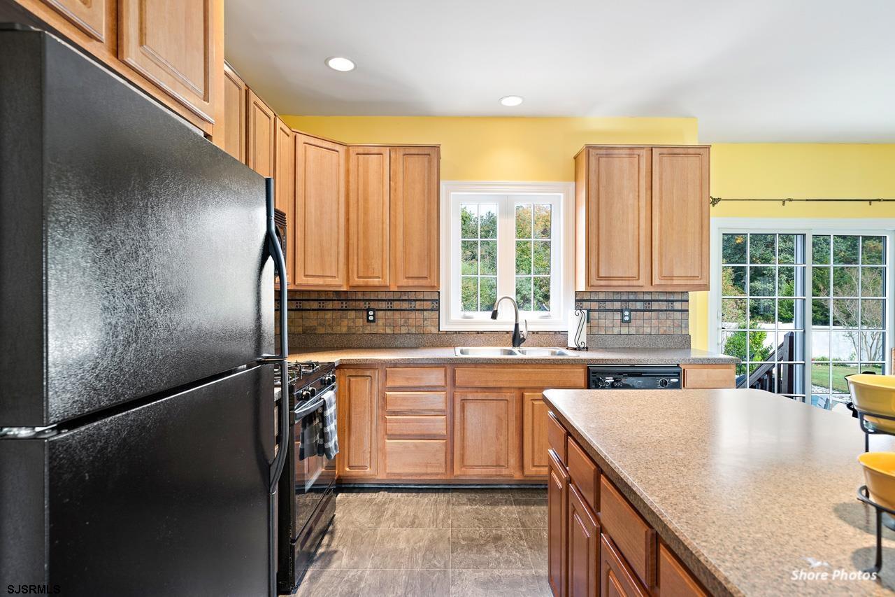 49 Killdeer Hill Road Woodbine, NJ 08270 - Photo 19 of 56 a kitchen with stainless steel appliances granite countertop a sink a stove and a refrigerator