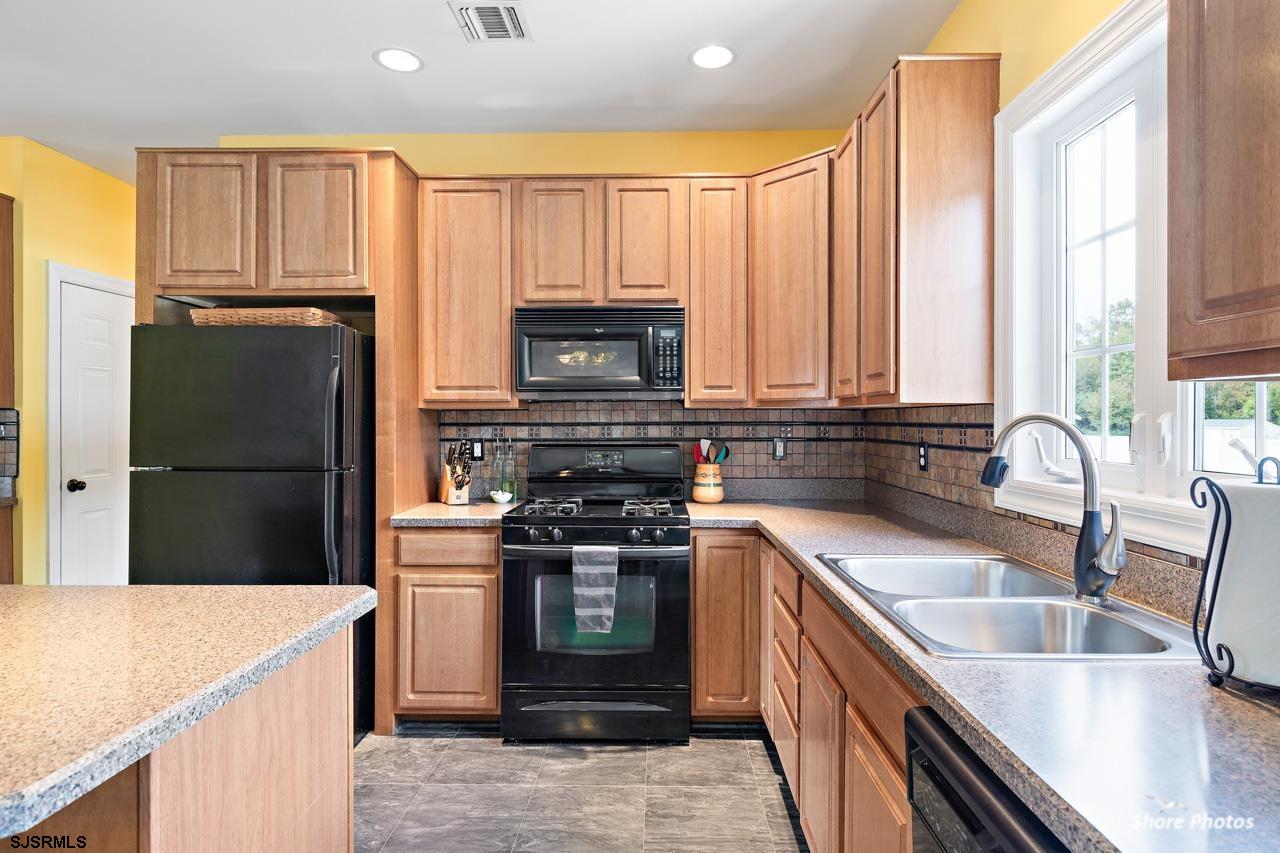 49 Killdeer Hill Road Woodbine, NJ 08270 - Photo 20 of 56 a kitchen with a stove a sink and a refrigerator