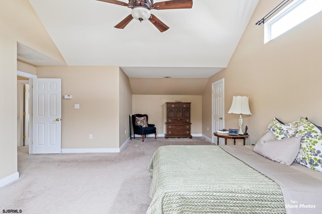 49 Killdeer Hill Road Woodbine, NJ 08270 - Photo 31 of 56 a spacious bedroom with a bed a chandelier and mirror