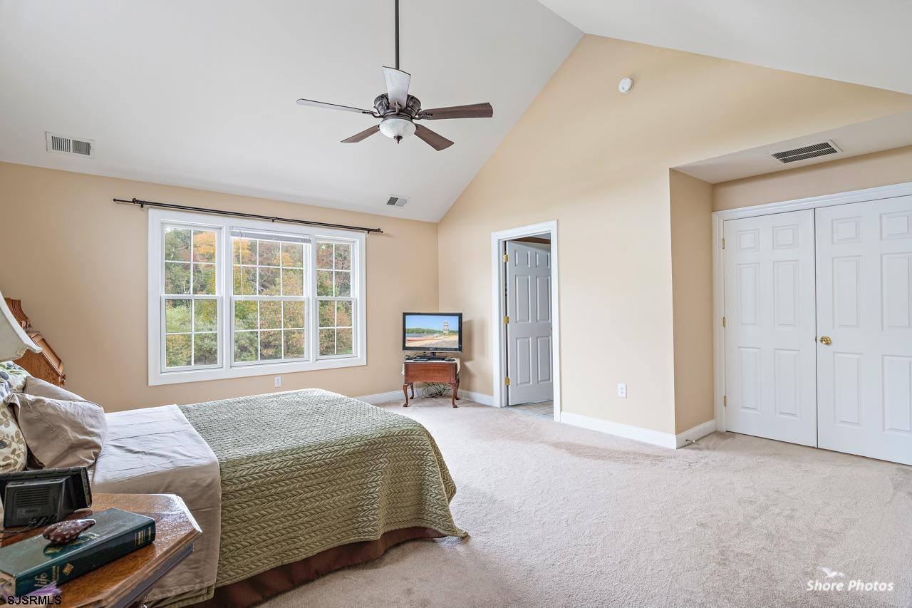 49 Killdeer Hill Road Woodbine, NJ 08270 - Photo 32 of 56 a bedroom with a bed and a chandelier