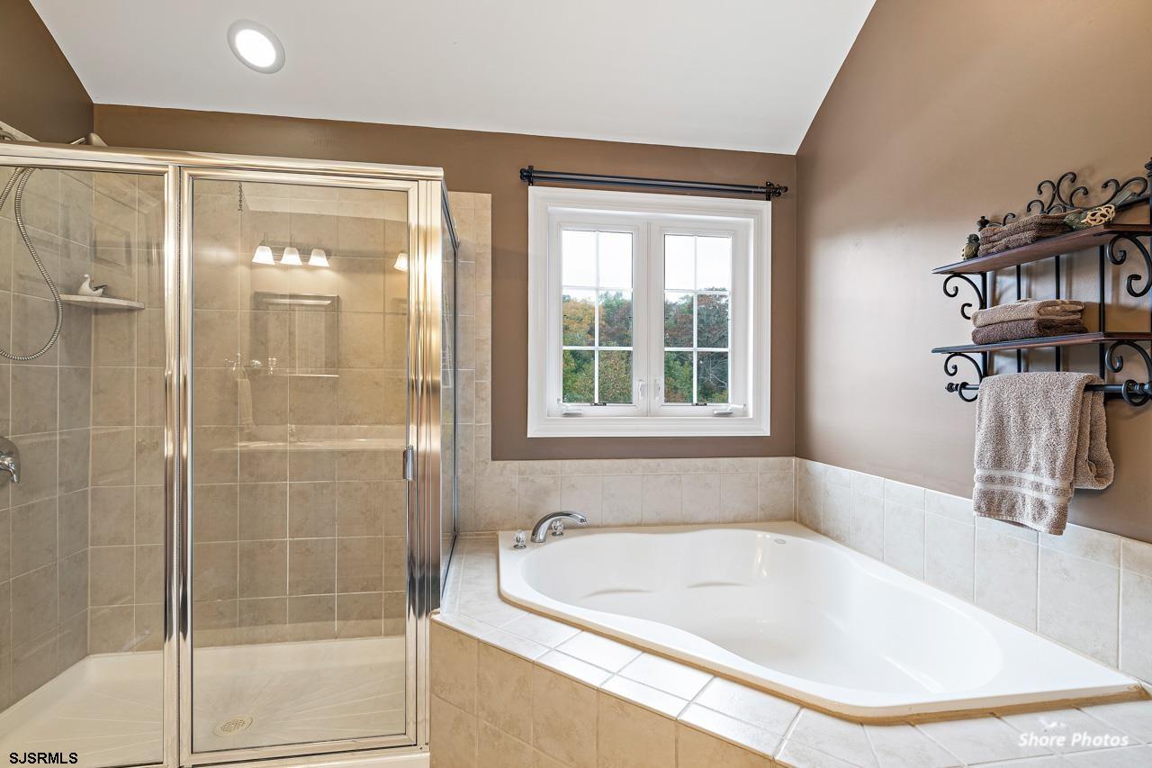 49 Killdeer Hill Road Woodbine, NJ 08270 - Photo 35 of 56 a bathroom with a tub and a shower