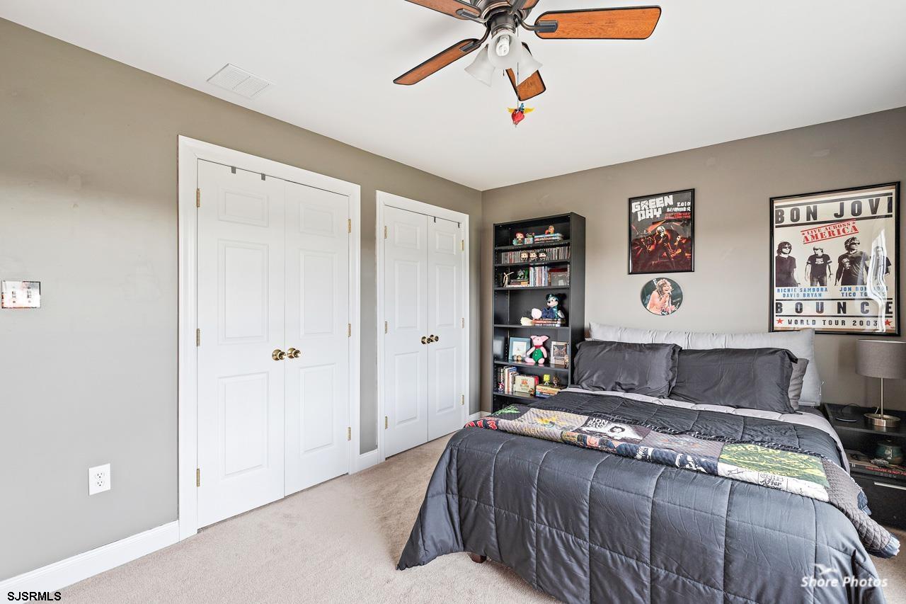 49 Killdeer Hill Road Woodbine, NJ 08270 - Photo 37 of 56 a bedroom with a large bed and a chandelier