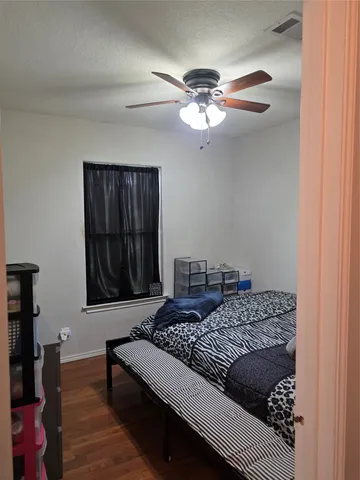 a living room with a couch and a dresser