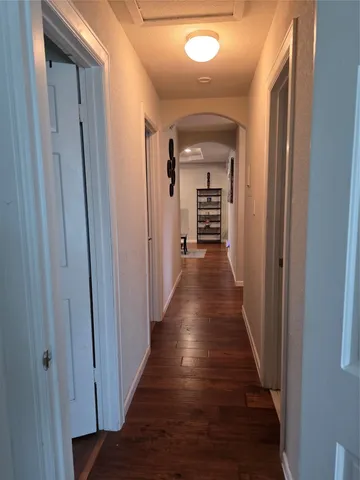 a view of hallway with wooden floor