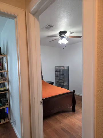 a bed room with a bed and a ceiling fan