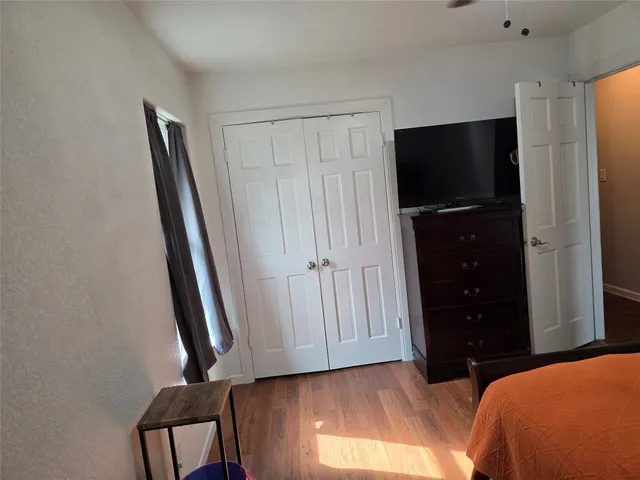 a bedroom with a bed and a mirror