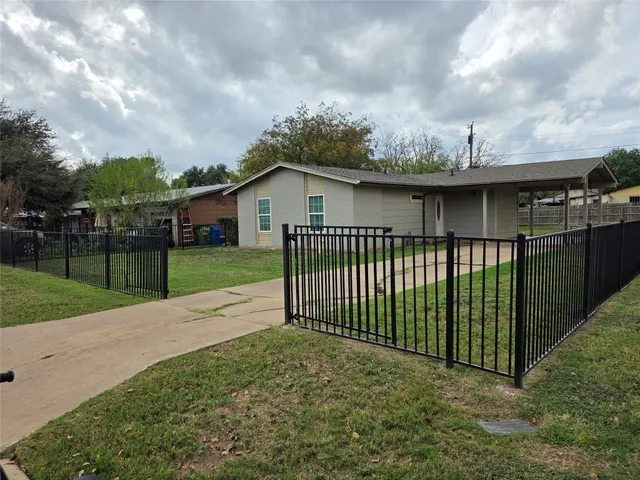 a view of a wrought iron fences in front of house