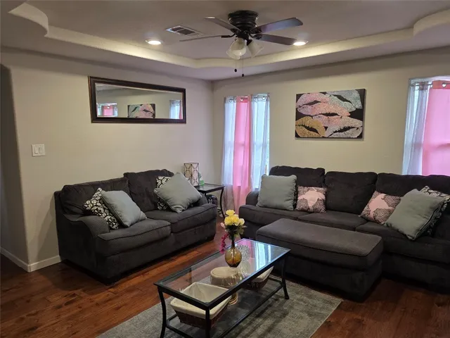 a living room with furniture a couch and paintings on the wall