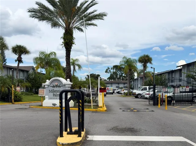 a front view of a building with parked cars