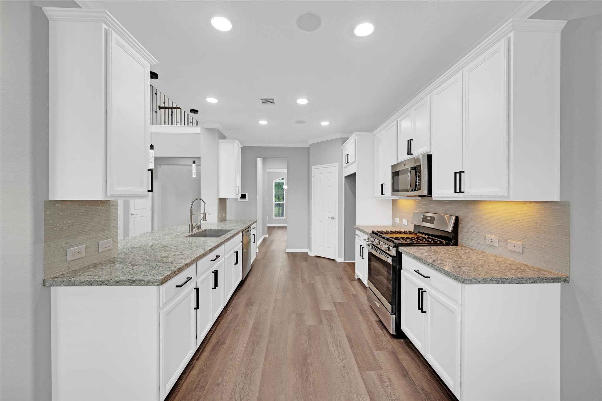 3834 Supremes Trail Spring, TX 77386 - Photo 13 of 36 a large kitchen with stainless steel appliances granite countertop a lot of counter space and wooden floors