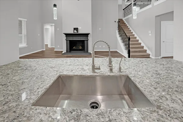 a bathroom with a granite countertop tub sink and mirror
