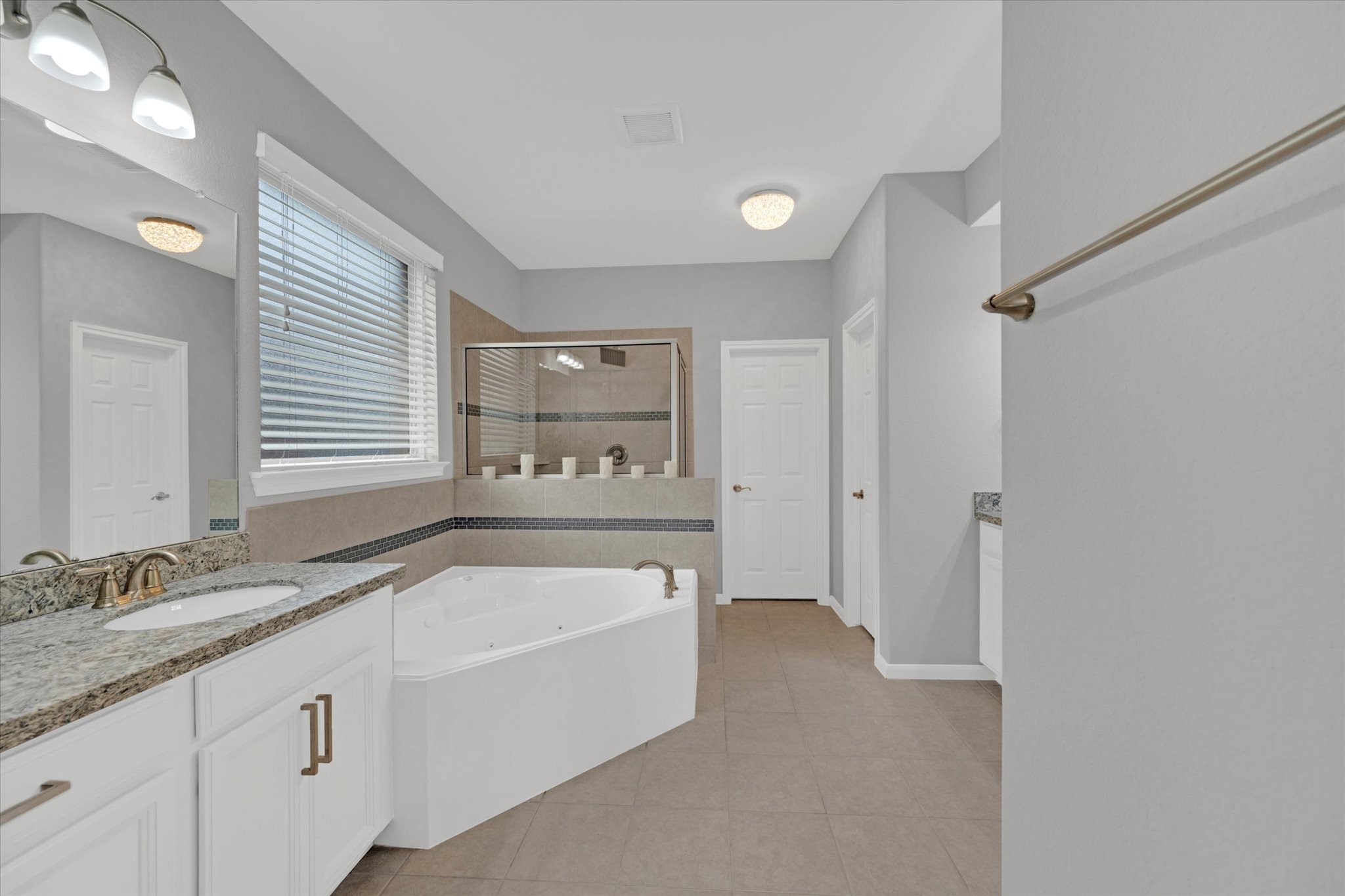 3834 Supremes Trail Spring, TX 77386 - Photo 22 of 36 a bathroom with a granite countertop tub sink and mirror