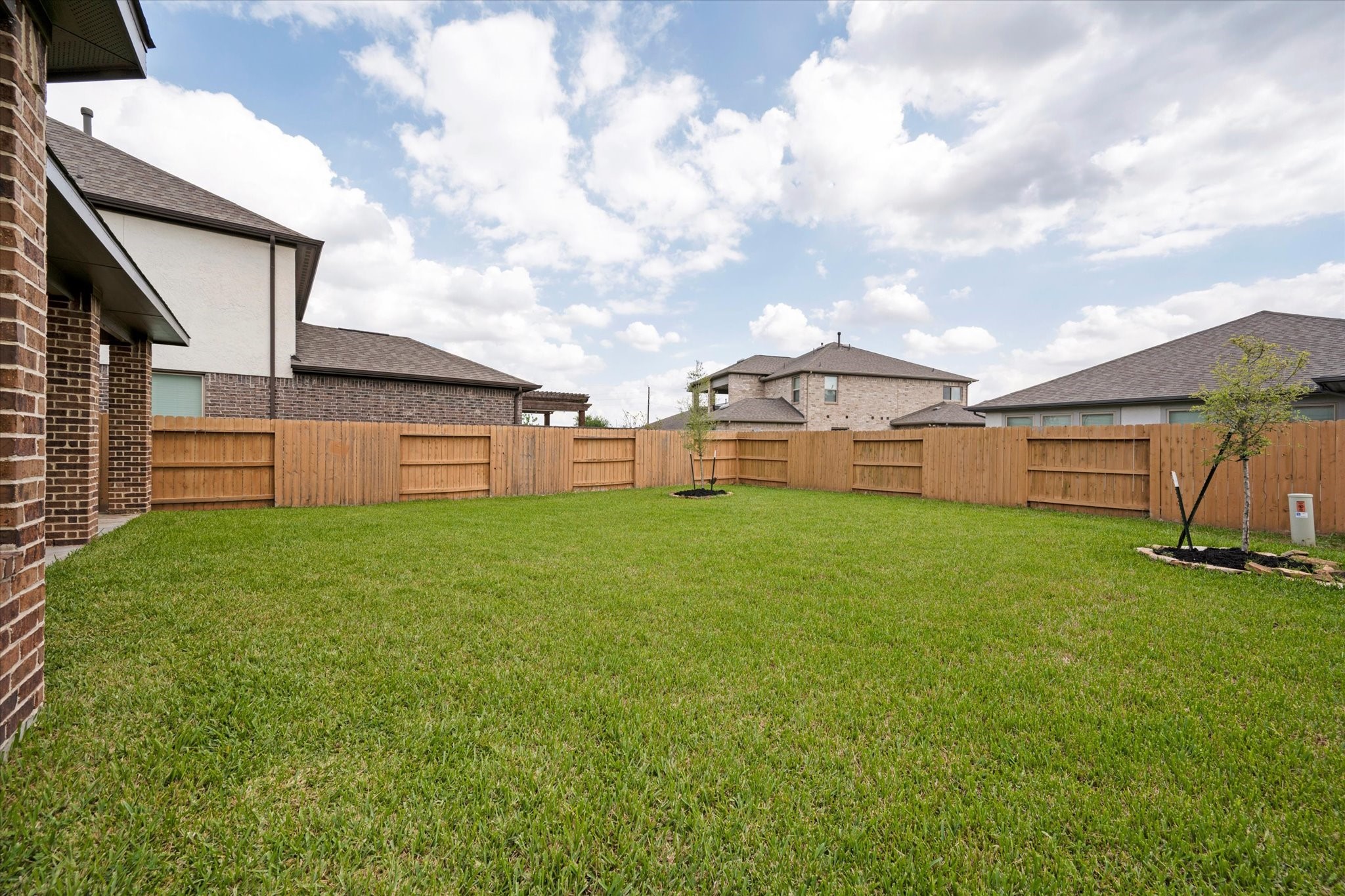 3834 Supremes Trail Spring, TX 77386 - Photo 35 of 36 a view of a big house with a big yard potted plants and wooden fence