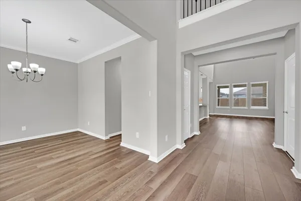 a view of an entryway with wooden floor fireplace and a window