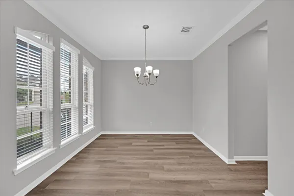 a large kitchen with stainless steel appliances granite countertop a lot of counter space and wooden floors