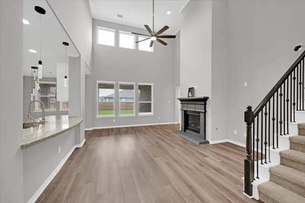 a kitchen with granite countertop a stove top oven a sink a counter space and cabinets