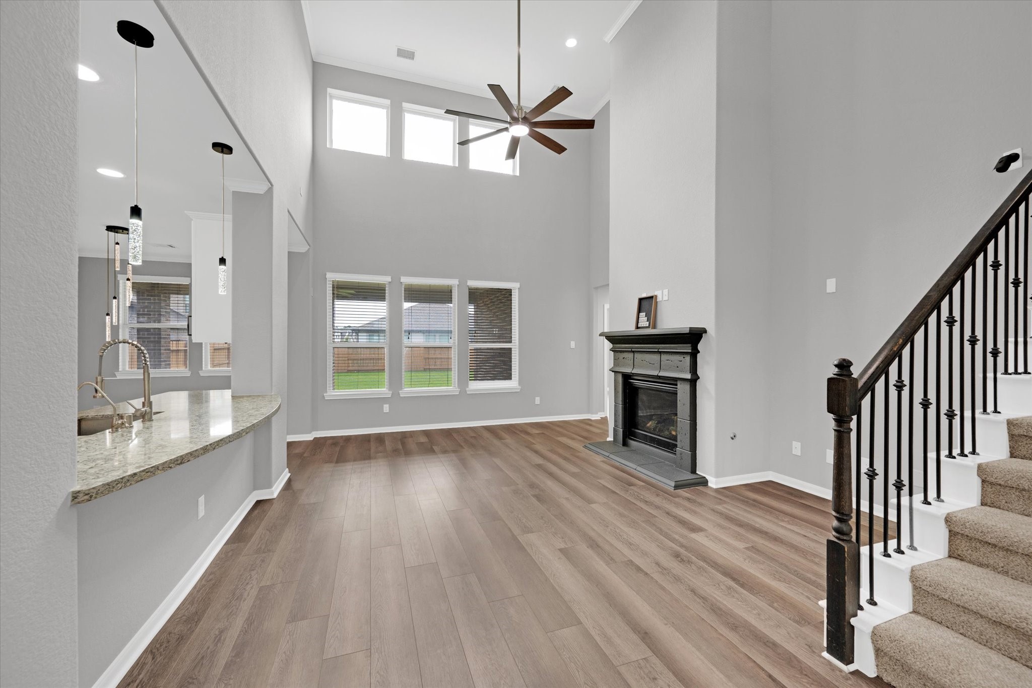 3834 Supremes Trail Spring, TX 77386 - Photo 9 of 36 an empty room with wooden floor fireplace and windows