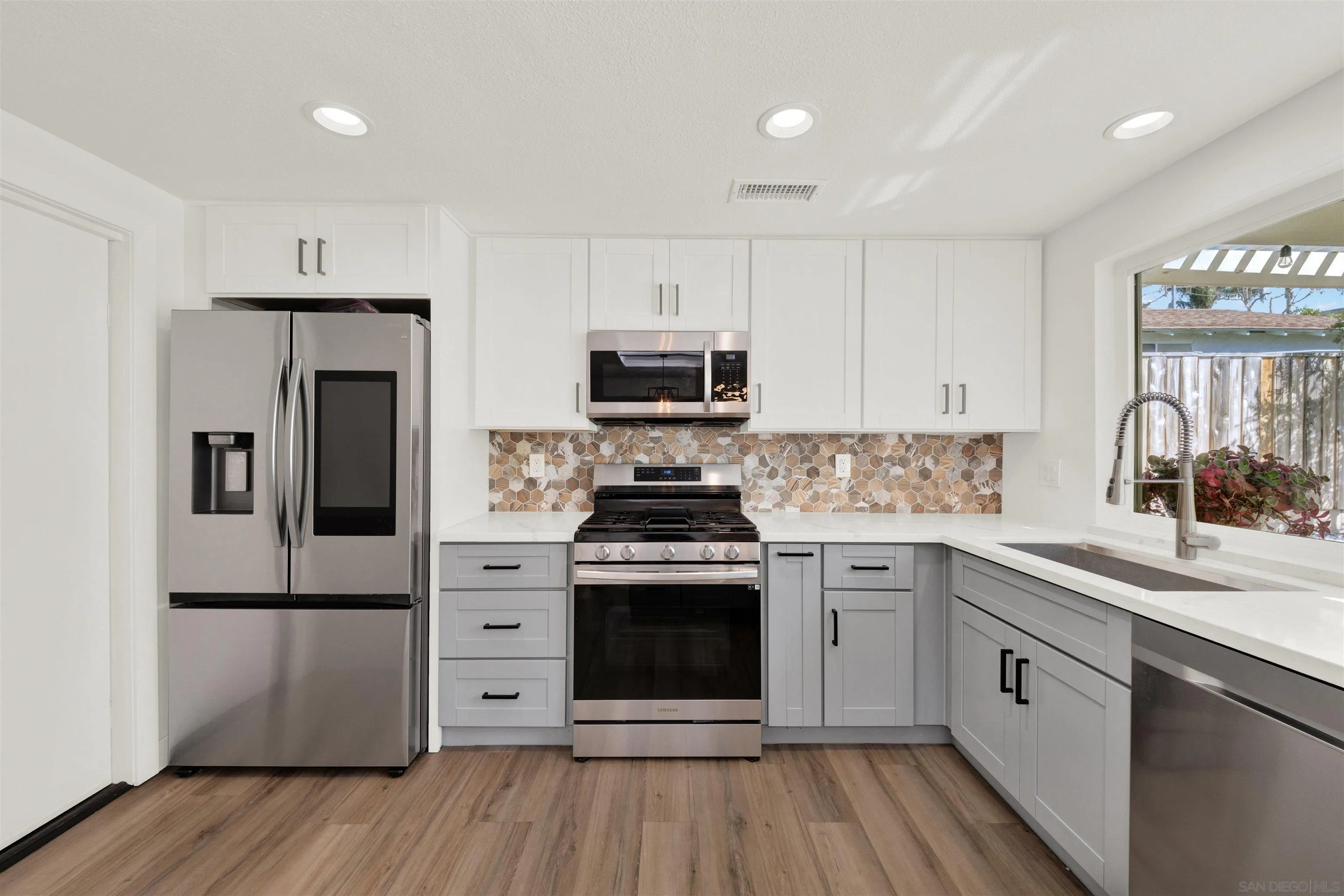 12435 Old Pomerado Road Poway, CA 92064 - Photo 19 of 53 a kitchen with stainless steel appliances granite countertop a stove and a refrigerator