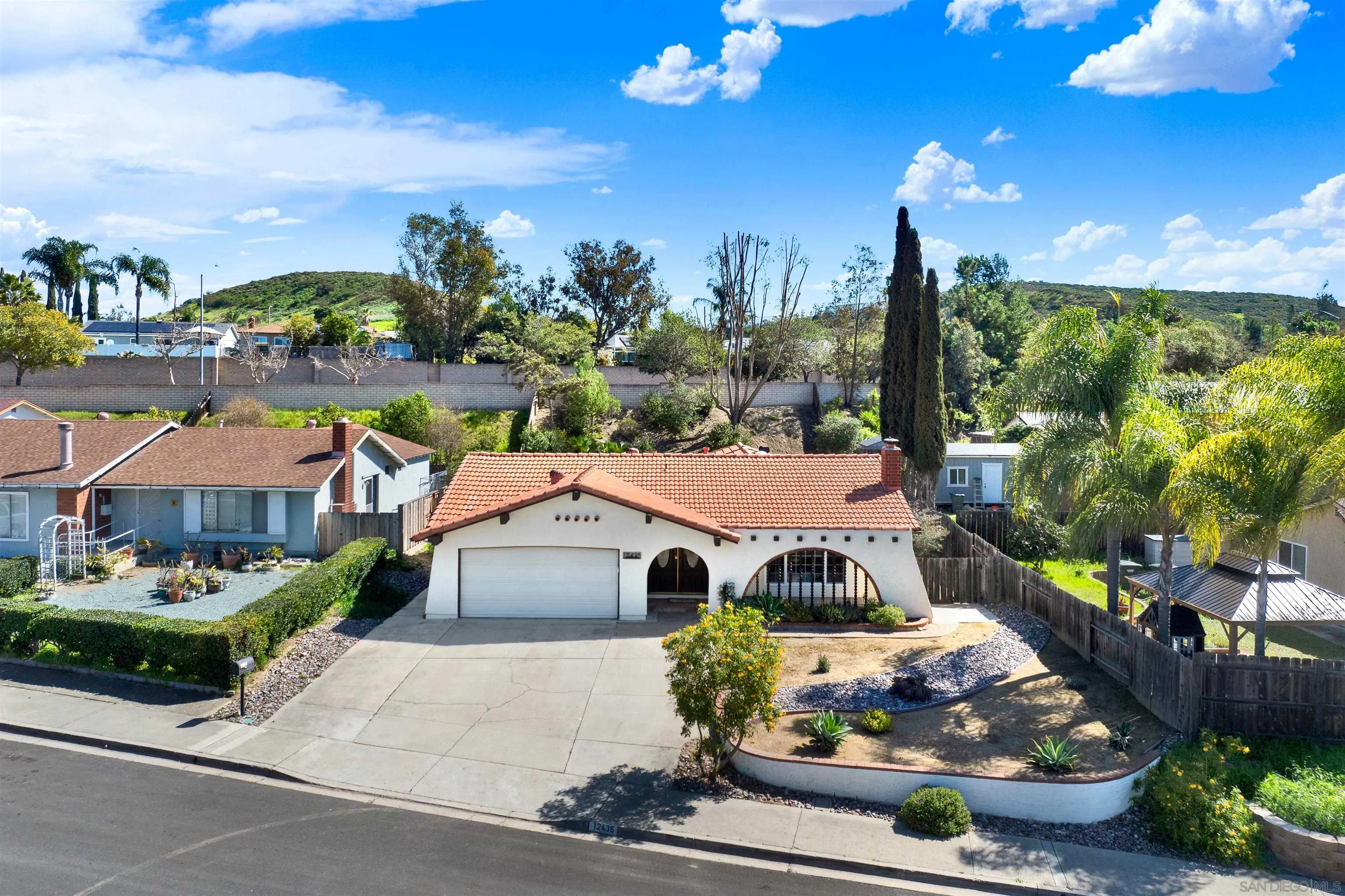 12435 Old Pomerado Road Poway, CA 92064 - Photo 4 of 53 a front view of a house with a yard and outdoor seating