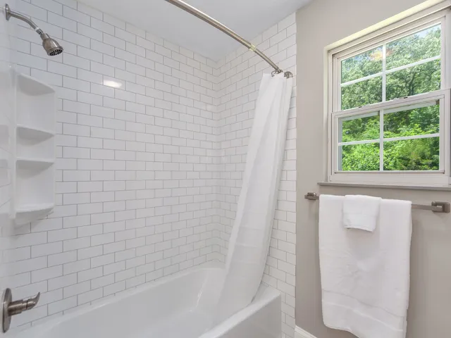a bathroom with a shower and a bathtub