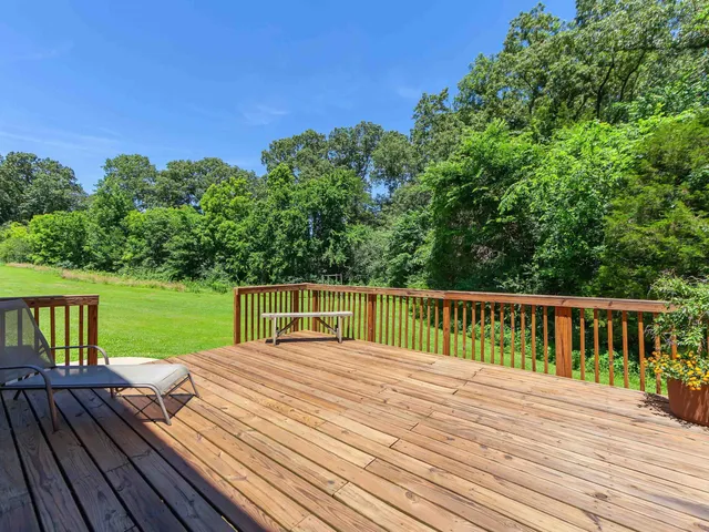 a view of a wooden deck and a yard