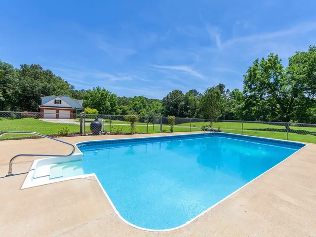 a view of swimming pool with a yard
