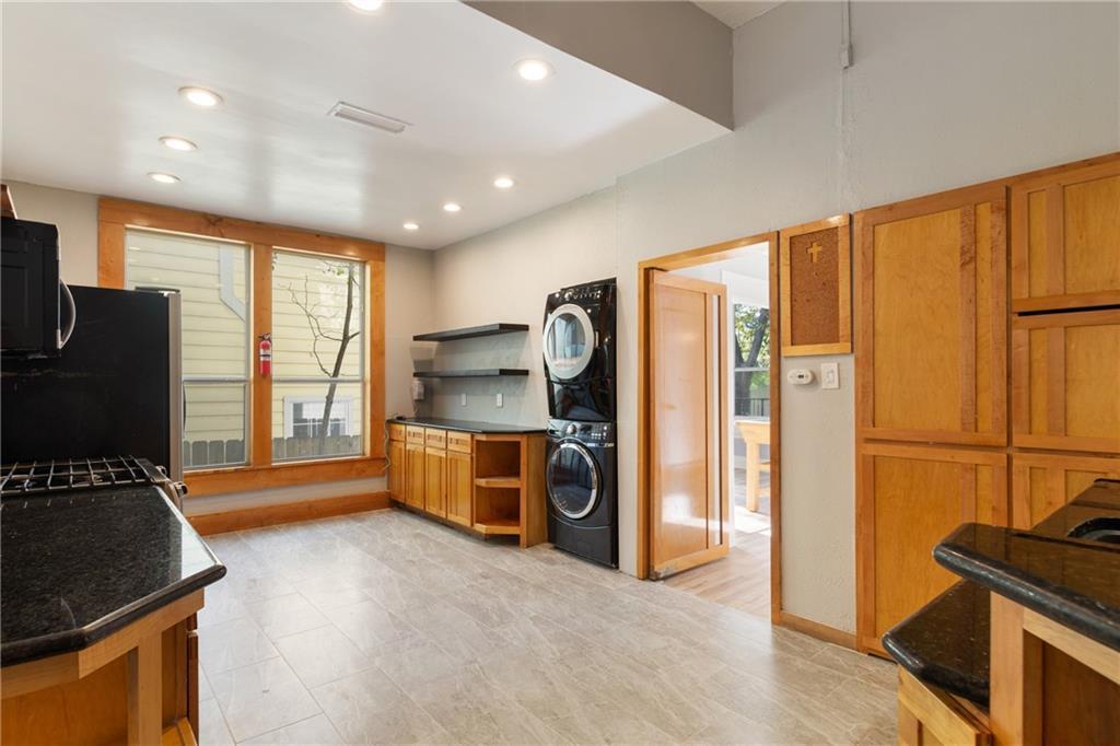 3210 Hampton Road, Unit A Austin, TX 78705 - Photo 25 of 25 Gleaming tile floors and natural wood cabinetry anchor this versatile laundry and prep space.