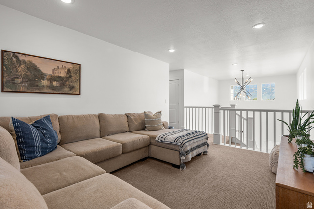 2706 West Maple Street, Unit 285 Mapleton, UT 84664 - Photo 15 of 36 Spacious loft area featuring neutral carpeting and white painted walls
