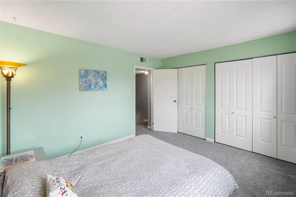 a bedroom with a bed and a painting