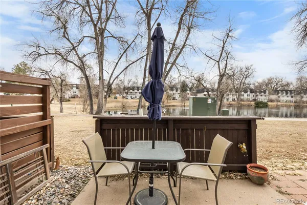 a backyard of a house with table and chairs