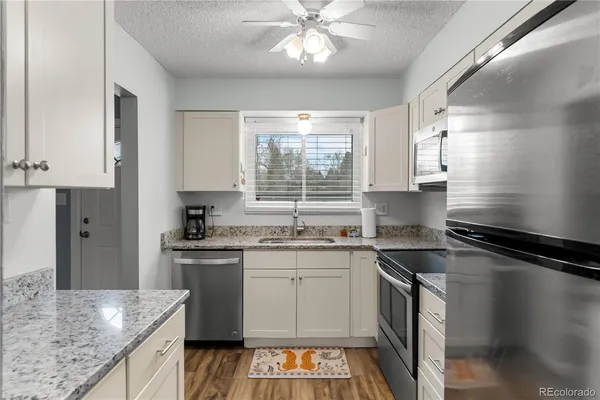 a kitchen with a sink stove and cabinets