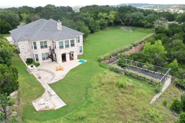 a aerial view of a house with a yard table and chairs